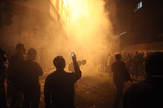 A man films the aftermath of a police-led teargas attack in Tahrir Square, Cairo. Nov 23 2011. Source: Peter Macdiarmid/ Getty Images